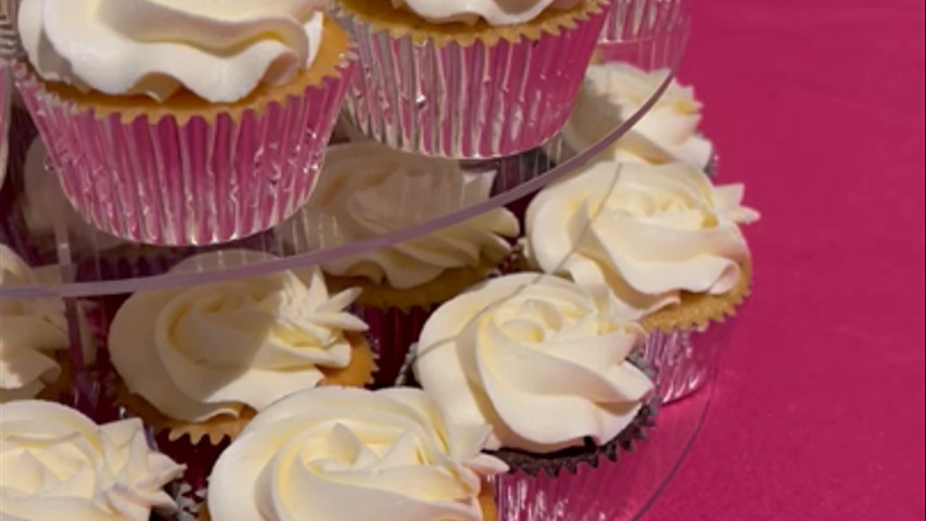 Cake, cupcake and sugar figure tower. 