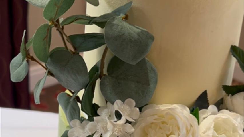 Close up view of three tier buttercream wedding cake