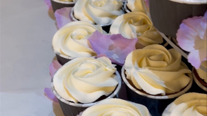 Close up of cake and cupcake wedding tower