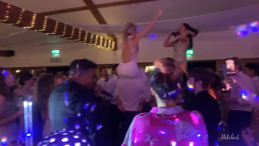 Bride on shoulders dancing